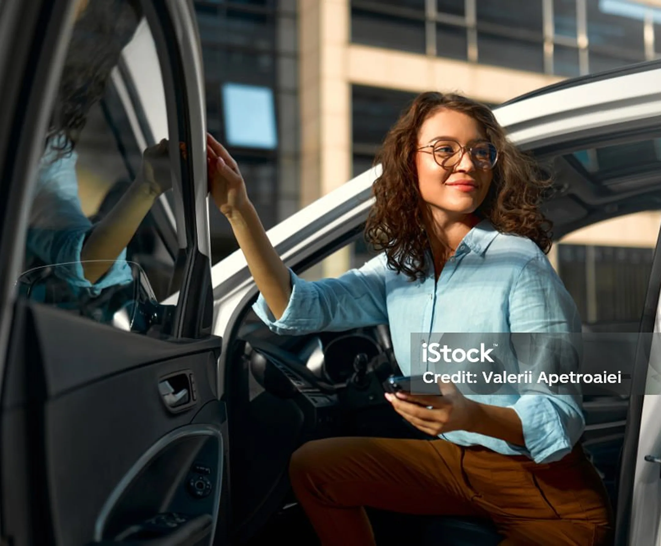 Woman getting out of car